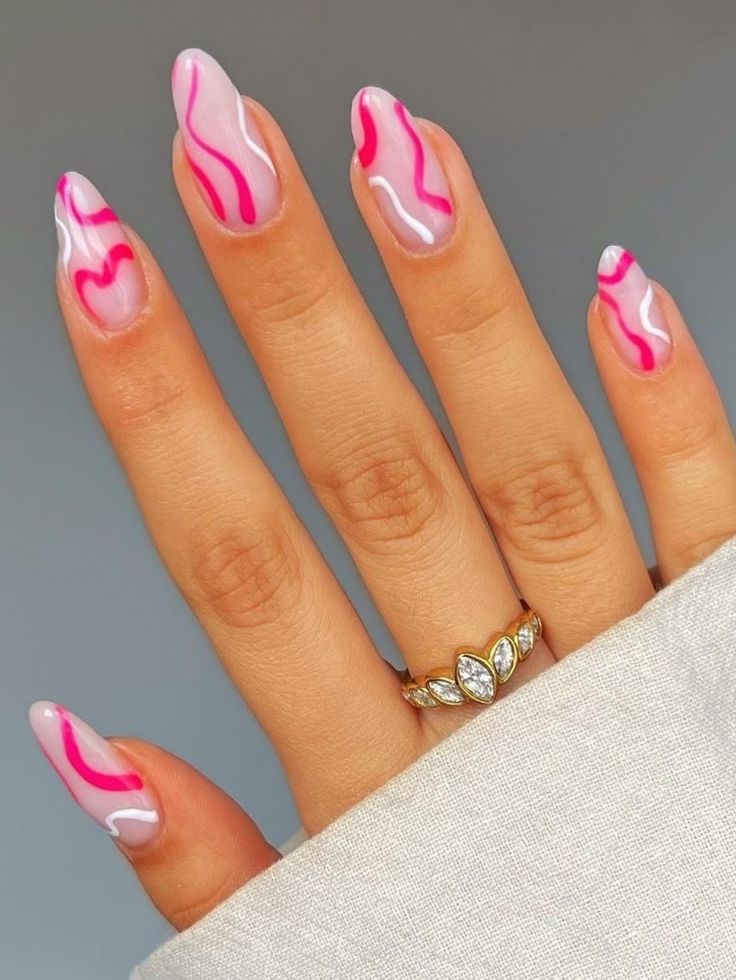 Elegant Gradient Pink Nail Design with Abstract Lines and Dainty Jewelry Accents.