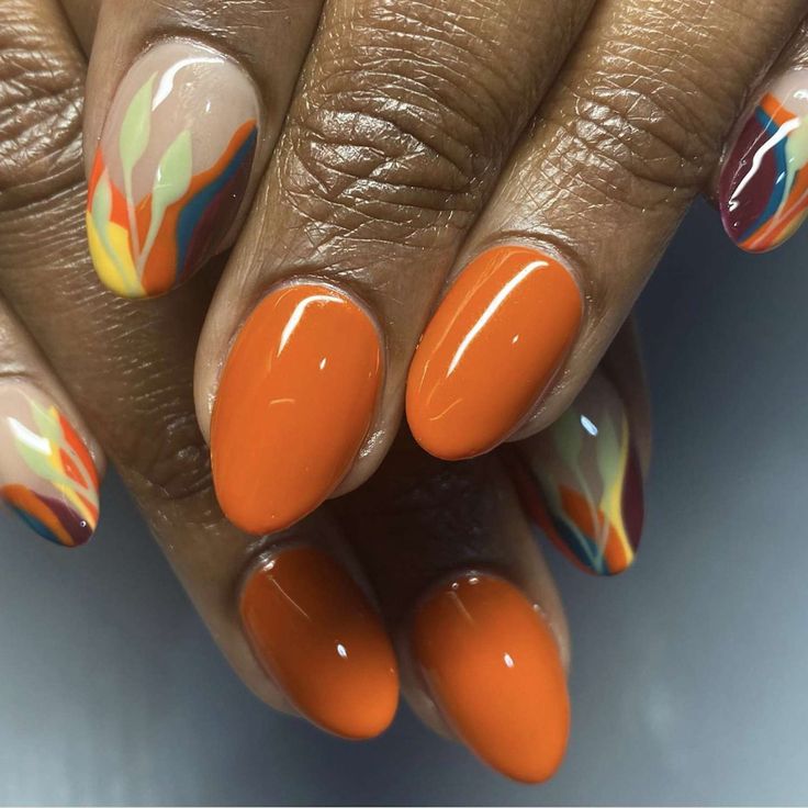 Bold and Elegant Autumn-Inspired Orange and Nude Nail Design with Artistic Accents.