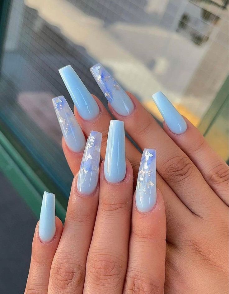 Elegant Pastel Blue Acrylic Nail Design with Accent Flakes for a Serene Aesthetic.