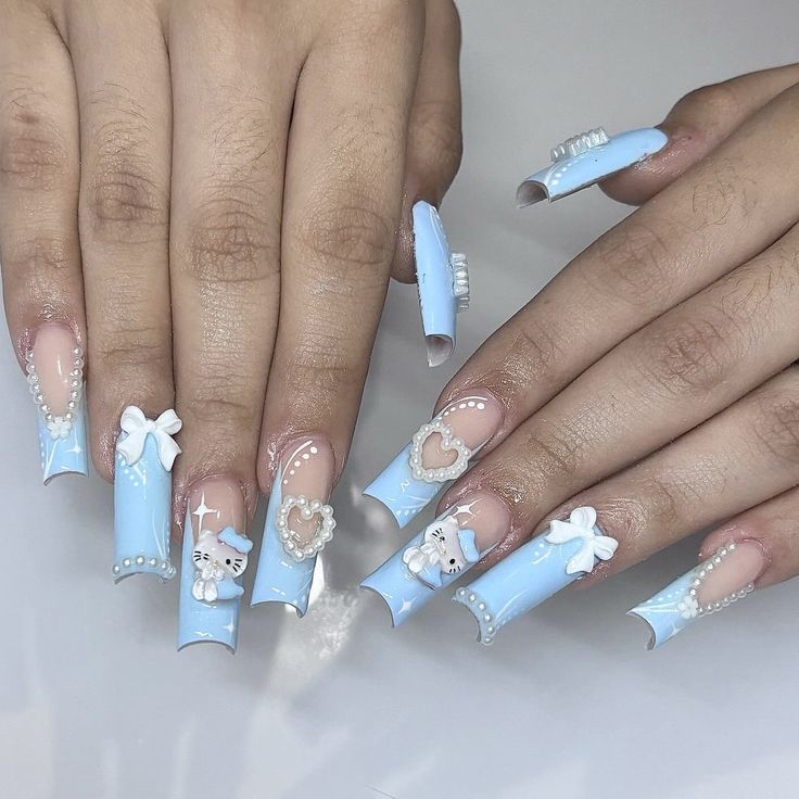 Whimsical Blue Acrylic Nails with Elegant Embellishments for Trendy Occasions.