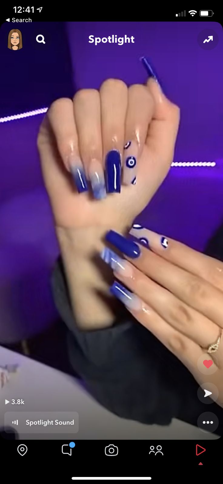 Chic Vibrant Blue Acrylic Nail Design with Gradient Effects and Playful Patterns.