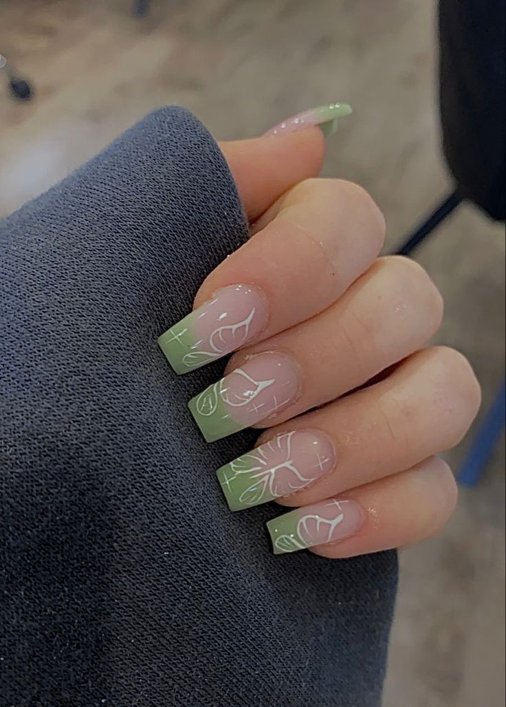 Sophisticated Ombre Nail Design with Pastel Green and Delicate Floral Line Art.