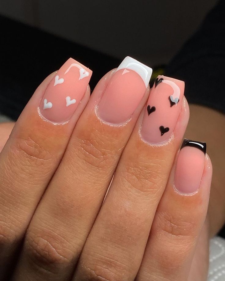 Charming Soft Pink Nail Design with Heart Patterns and Trendy Square Tips.