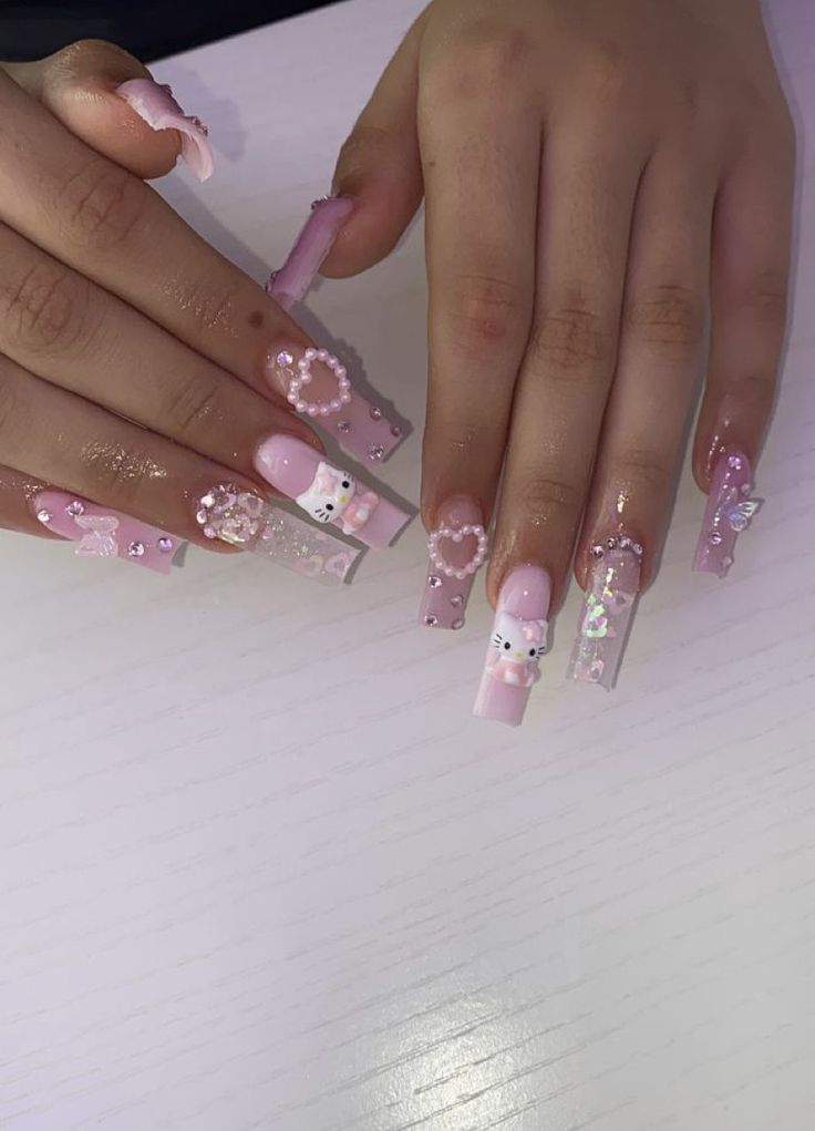 Whimsical Pastel Pink Nail Design with Charming Motifs and Embellishments