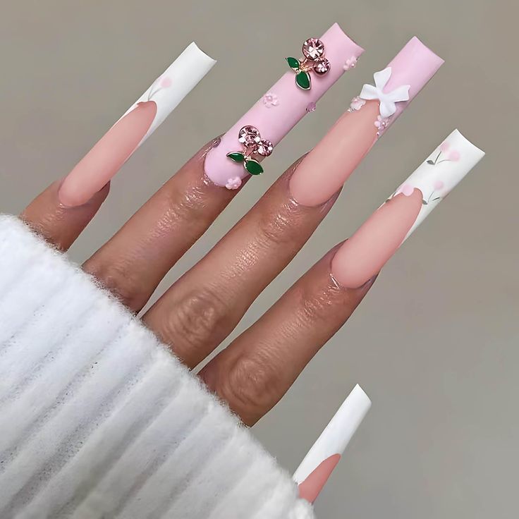 Sophisticated Elegance: Soft Pink Long Nails with Floral Designs and Delicate Embellishments.