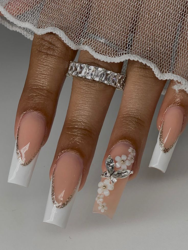 Sophisticated Elegant Nail Design with Nude and White Shades Featuring Pearl Accents and Butterfly Motif.