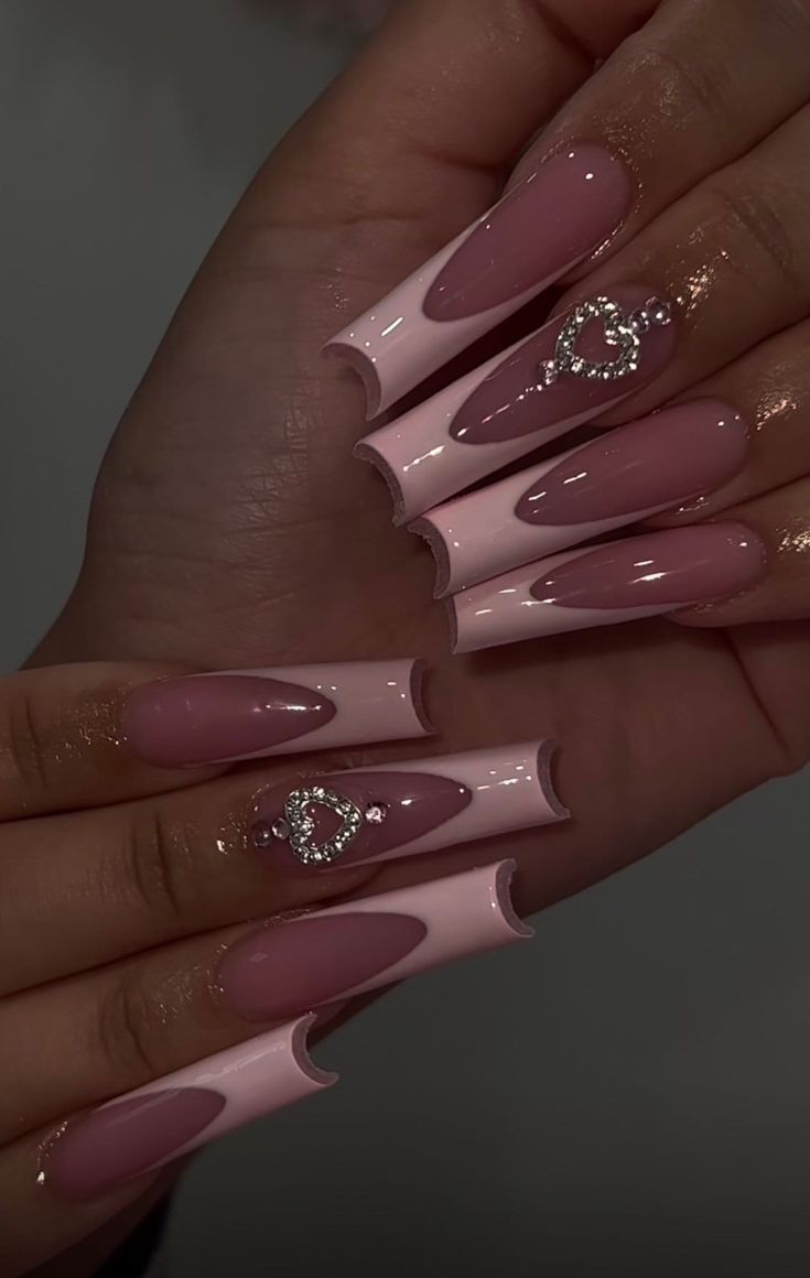 Chic Long Nails with Soft Pink and Nude Shades Enhanced by Elegant Heart Embellishments.