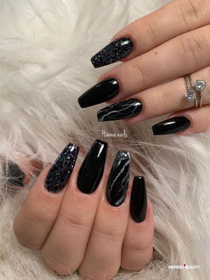 Chic Black Nail Design with Glossy, Glittery Finishes and Elegant Accents.