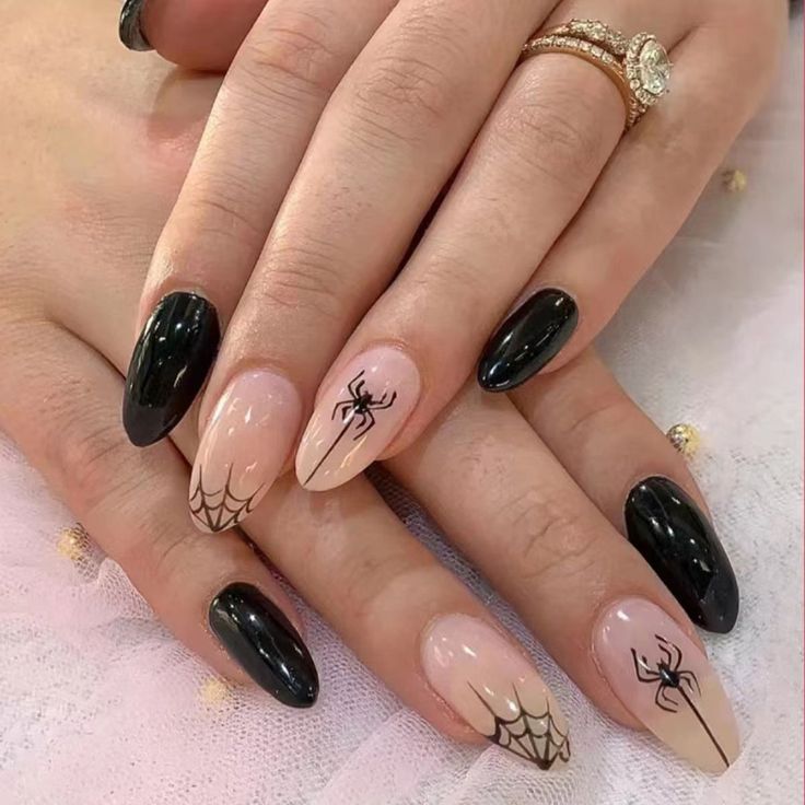 Striking Spider-Themed Nail Design: Matte Black and Nude Elegance.