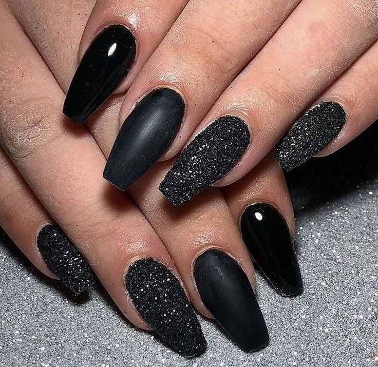 Chic Black Nail Design with Matte and Glitter Accents for a Sophisticated Look.