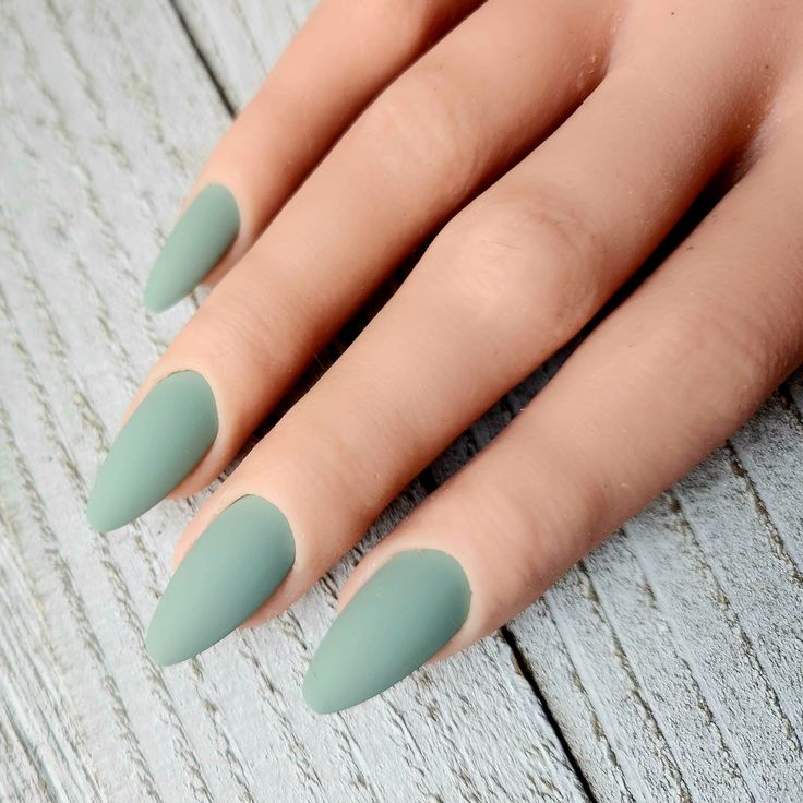 Chic Matte Green Almond-Shaped Nails: A Subtle Statement in Nail Design.