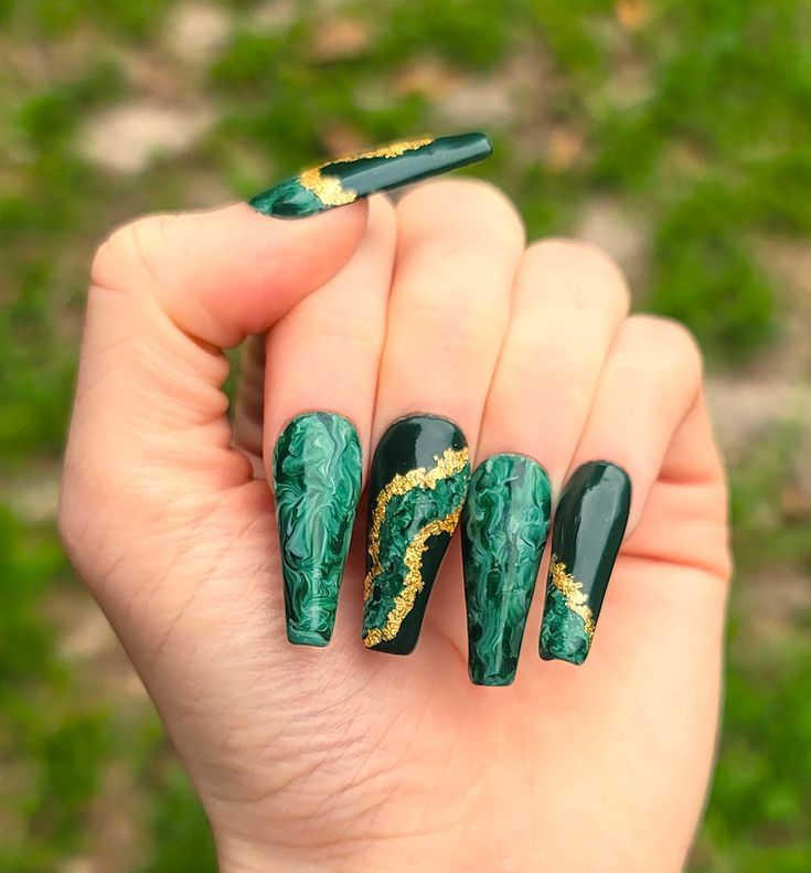 Elegant Marble-Inspired Nail Design with Deep Green and Gold Accents