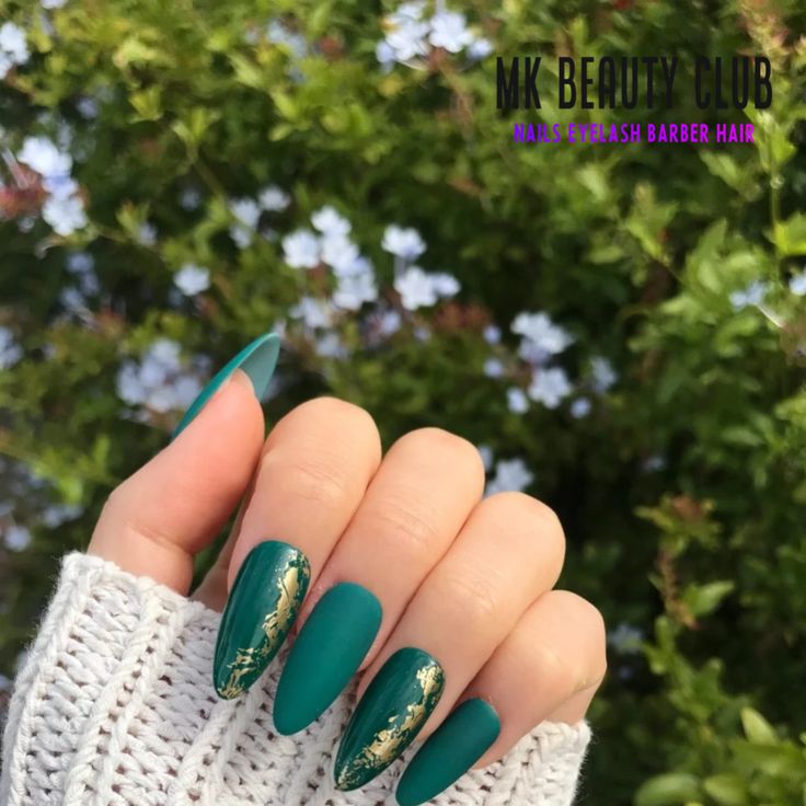 Sophisticated Elegant Green Stiletto Nails with Matte Finish, Glossy Accents, and Gold Foil Detailing.