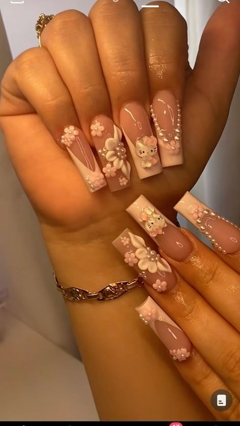 Elegant Soft Pink and Nude Nail Design with Floral Accents and 3D Details.