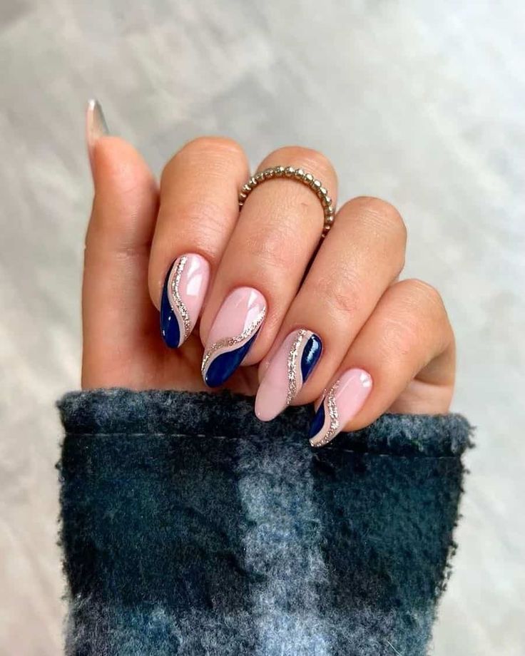 Sophisticated Wavy Navy Blue and Pink Nail Design with Silver Glitter Accents.