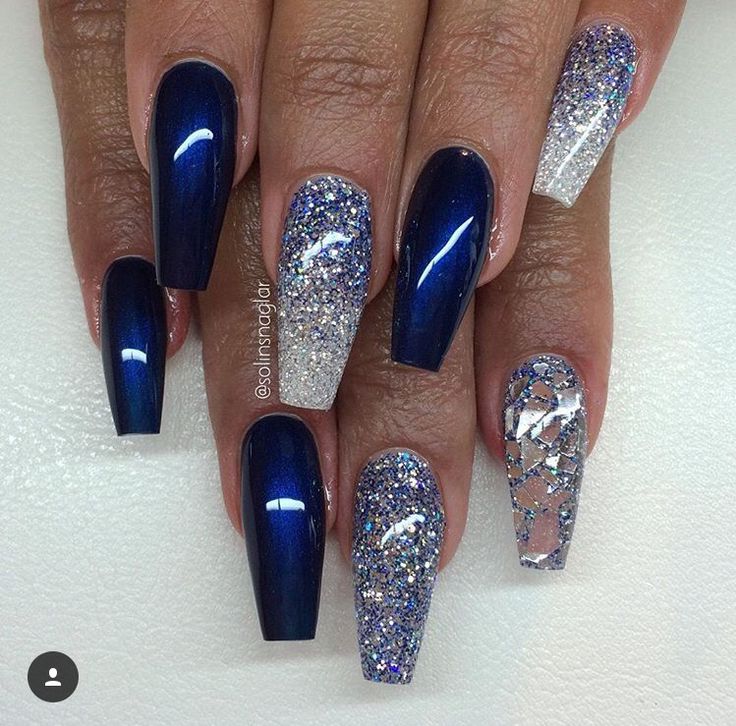 Elegant Navy Blue and Sparkling Silver Nail Design with Intricate Glitter Patterns.