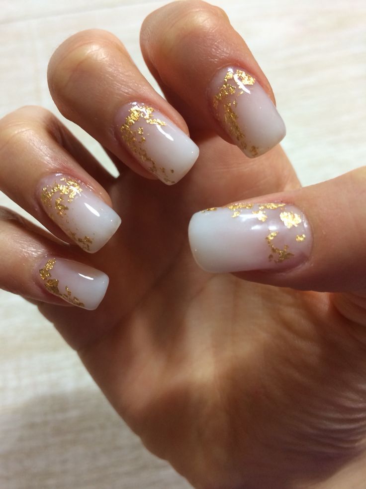 Elegant White Nail Design with Gold Foil for a Sophisticated Look.