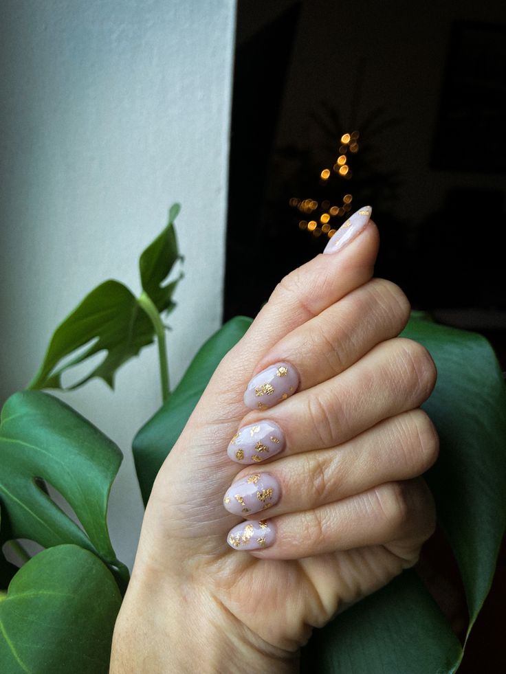 Sophisticated Soft Lavender and Gold Nail Design with Fresh Green Backdrop