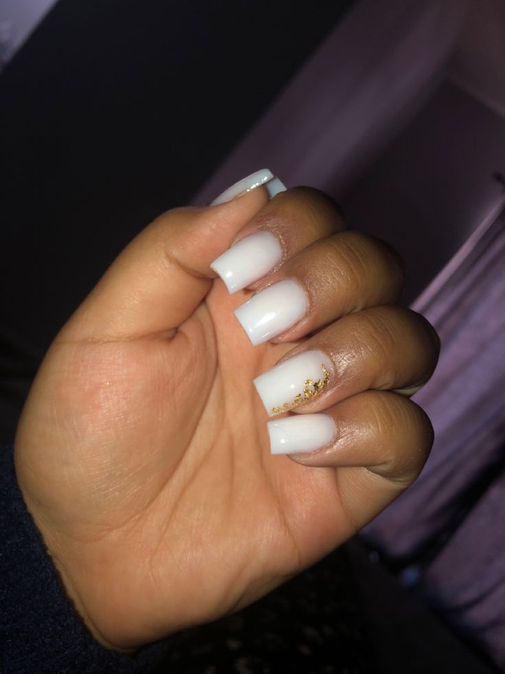 Sophisticated Glossy White Manicure with Chic Golden Accents