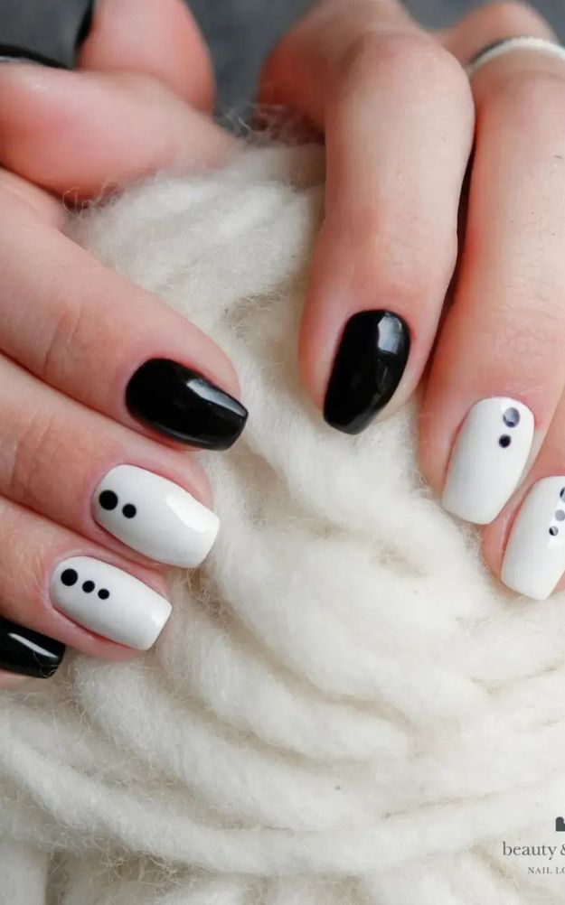 Chic Black and White Nail Design with Artistic Polka Dot Patterns for Any Occasion.