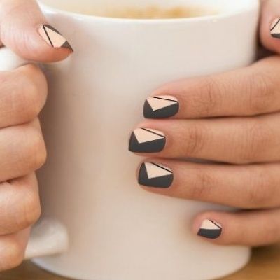 Chic Geometric Nail Design in Matte Black and Soft Peach Tones.