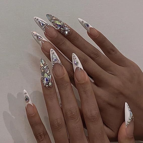 Chic Stiletto Acrylic Nails with Elegant White Polish and Glamorous Geometric Crystal Designs.