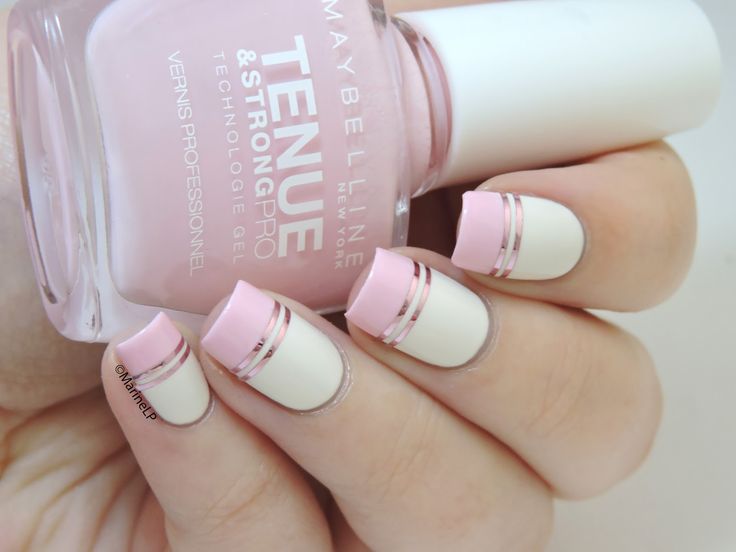 Chic Soft Pink and White Contemporary French Tip Nail Design with Metallic Stripes.