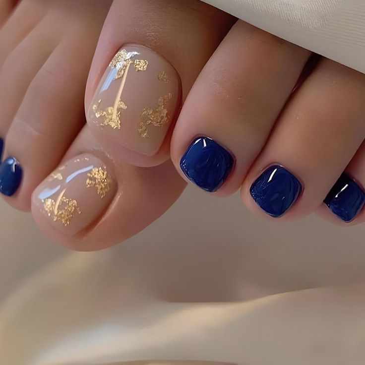 Chic Toenail Design: Soft Nude with Gold Foil and Deep Navy Accents