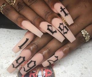 Chic Nude Acrylic Nails with Bold Black Designs: A Sophisticated Statement Look.