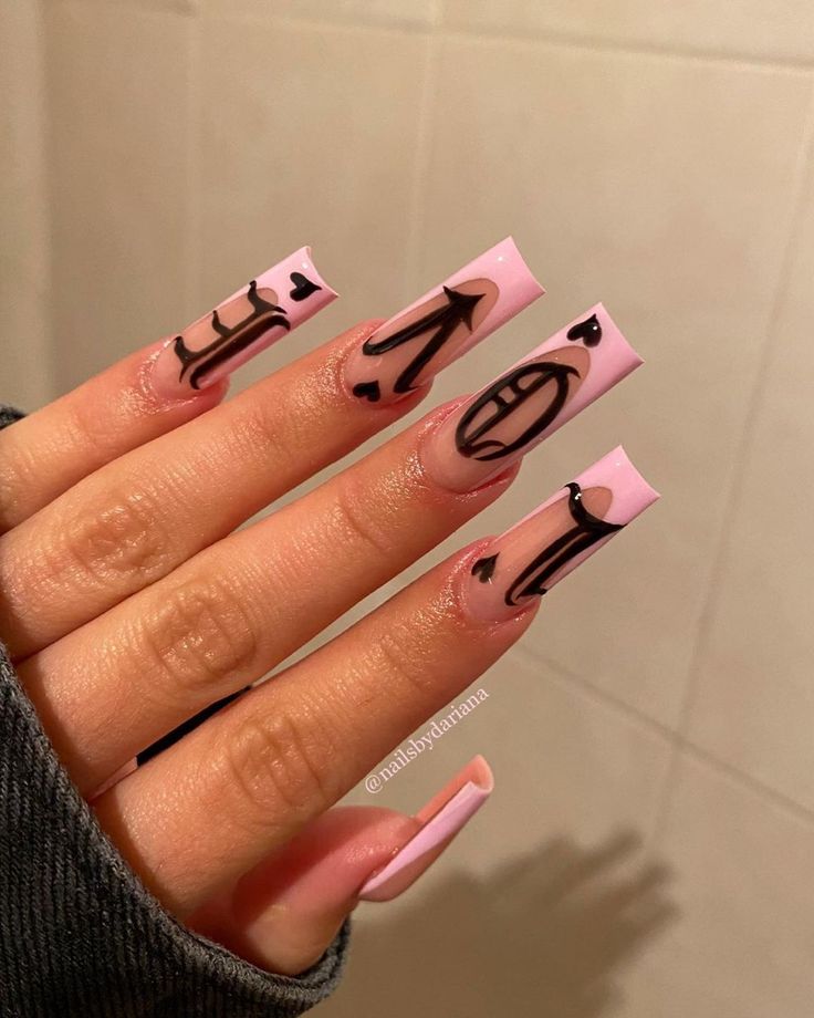 Playful Pink and Bold Dark Nail Design with Graphic Motifs and Charming Hearts.