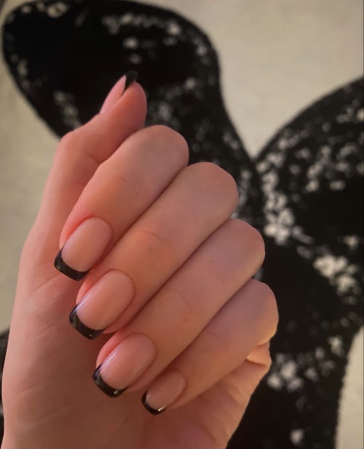 Chic Nude and Bold Black Tip Nail Design: A Versatile Elegance for Any Occasion.