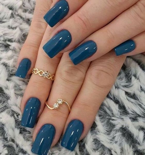 Sophisticated Glossy Teal Nail Design with Elegant Gold Accents.