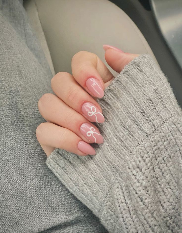 Chic Soft Pink Nail Design with Matte Glossy Finishes and Playful Bow Accents.