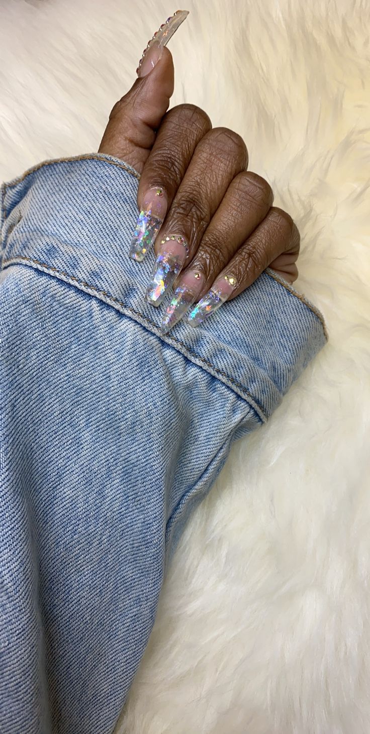 Elegant Sparkling Nail Design with Holographic Glitter and Pastel Accents on Elongated Acrylic Tips.