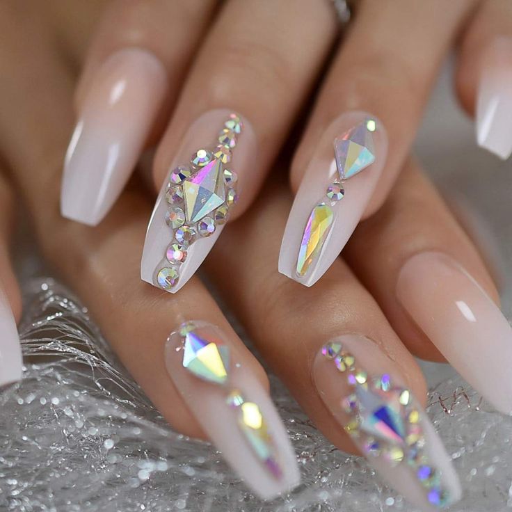 Chic Elegant Nails: Glossy Elongated Shapes with Iridescent Gems and Rhinestones.