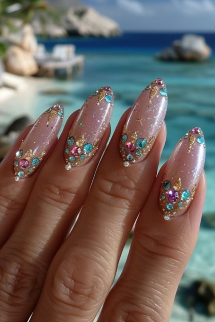 Glamorous Soft Pink and Gold Nail Design with Colorful Rhinestones.