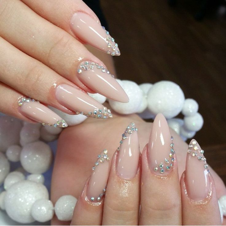 Sophisticated Almond-Shaped Nails with Sparkling Rhinestones and Soft Nude Polish.