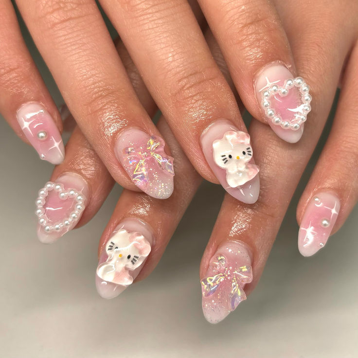 Whimsical Pastel Pink Nail Art with 3D Elements and Glamorous Embellishments.