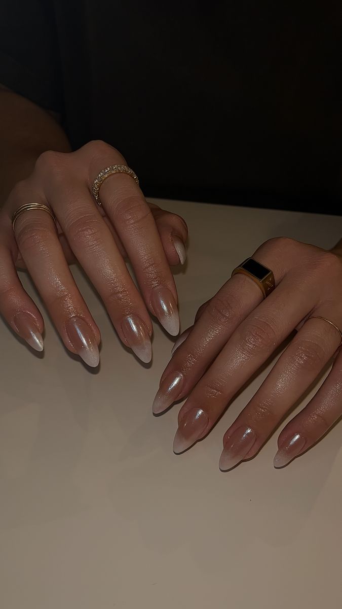 Chic Almond-Shaped Ombre Nails with Glossy Finish and Gold Ring Accents.