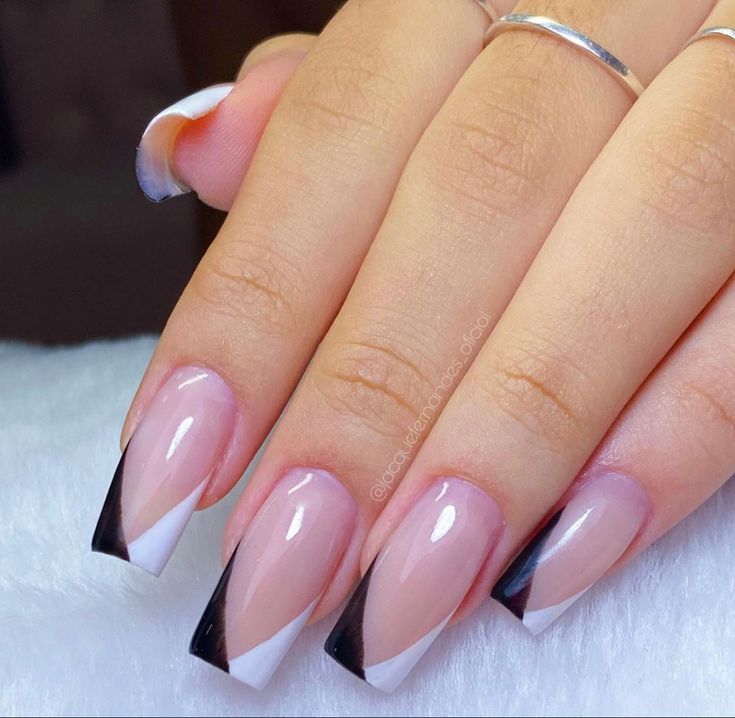 Chic French Manicure with Bold Black Tips and Geometric Patterns.