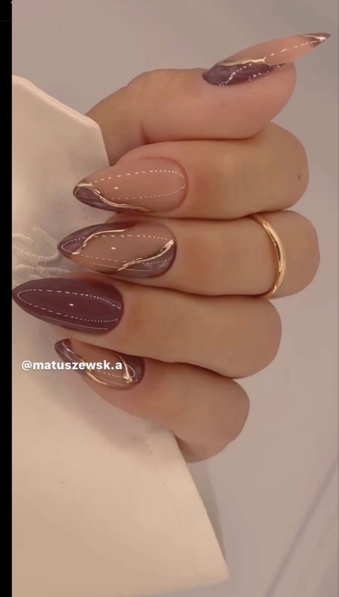 Sophisticated Elongated Almond Nail Design in Muted Mauve and Soft Nude with Elegant Line Art.