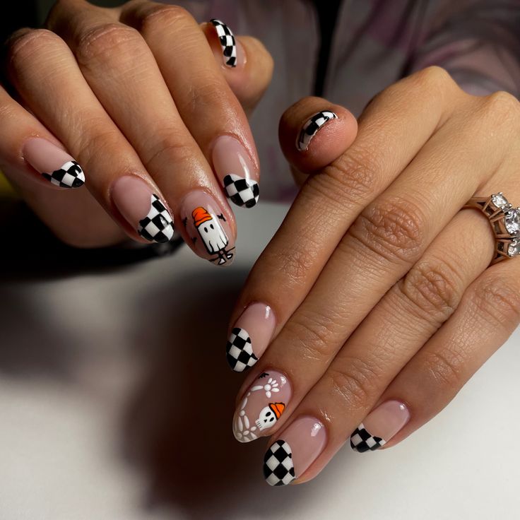 Chic Halloween Nail Design: Elegant Almond Shape with Playful Checkered Patterns and Festive Ghosts.