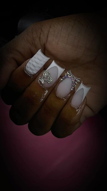 Elegant Intricate Nail Design with White and Nude Shades, Textures, and Crystals.