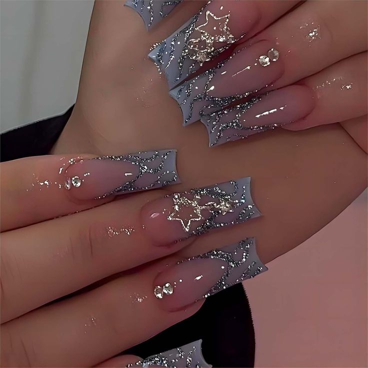 Elegant Light Blue Glitter Tips with Star Motifs for a Glamorous Nail Design.