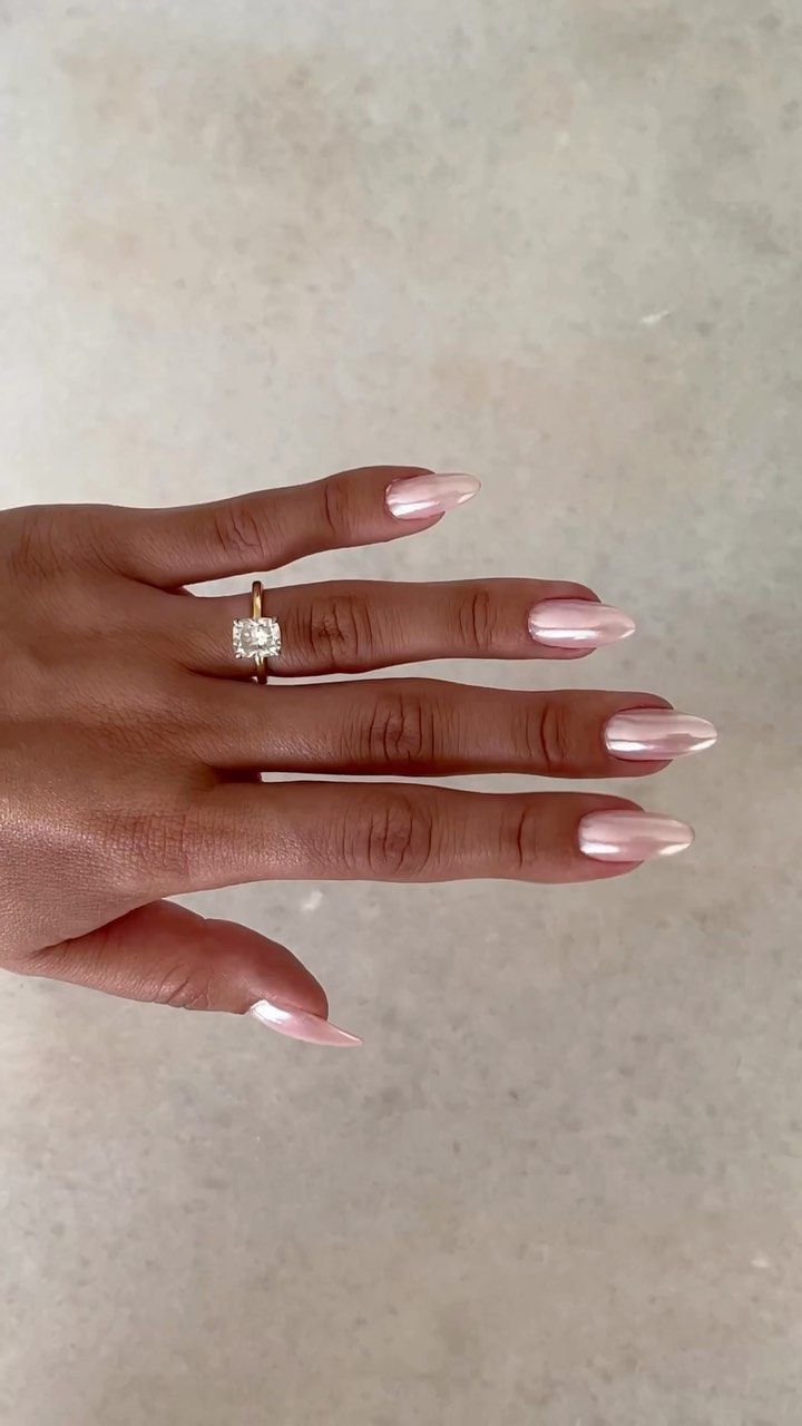 Chic Almond-Shaped Blush Nails Paired with a Sophisticated Gold Ring.