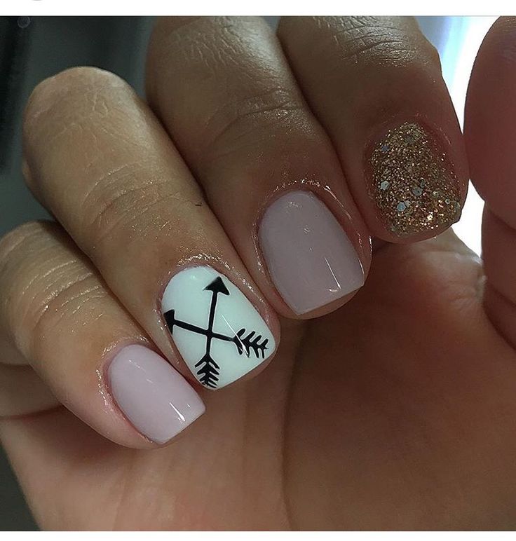 Chic Minimalist Nail Design: Soft Pink Base with White Arrows and Sparkling Gold Accent.