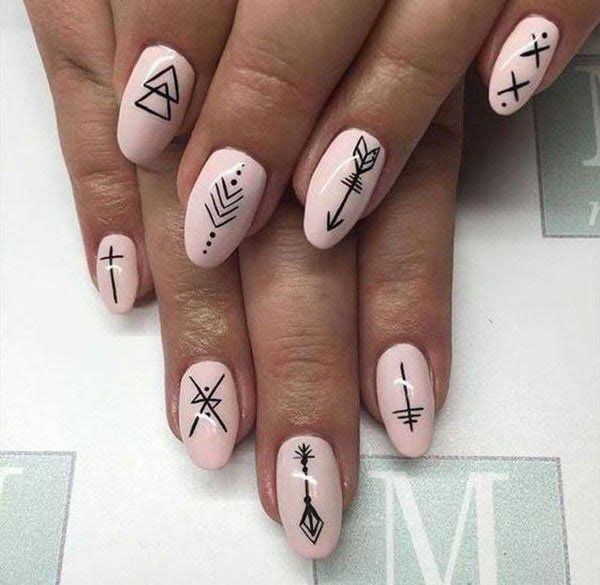 Chic Minimalist Geometric Nail Design with Black Symbols on Soft Pink Base