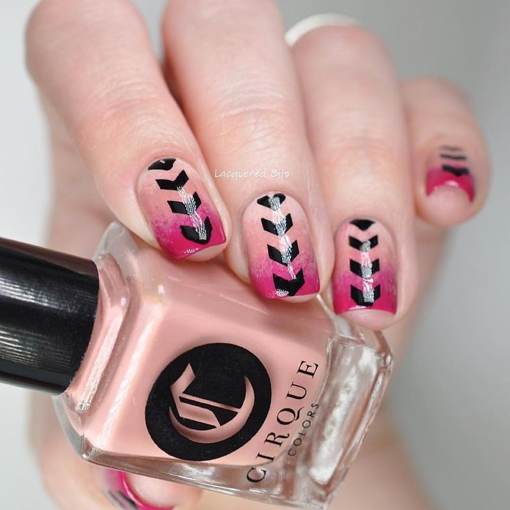 Chic Gradient Pink and Nude Nail Design with Bold Black Chevron Patterns.