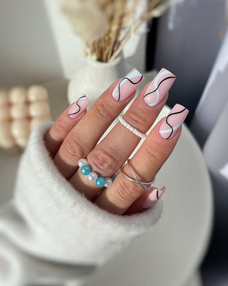 Chic Pink Nail Design with Elegant Black Accents and Delicate Ring Detail