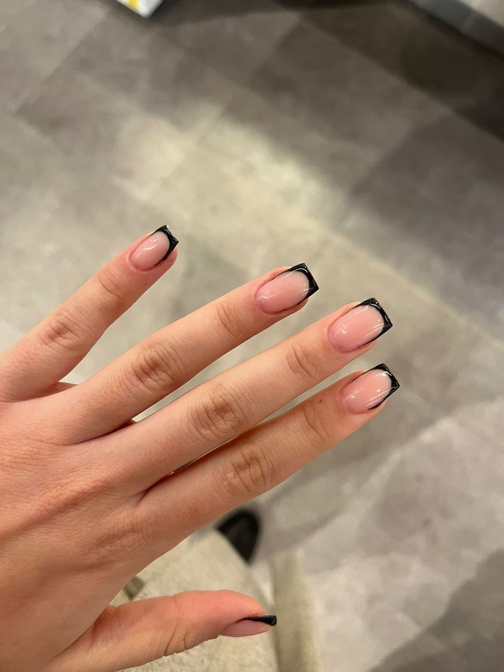 Sophisticated Nude and Black Tip Nail Design: A Modern Take on French Manicure Elegance.